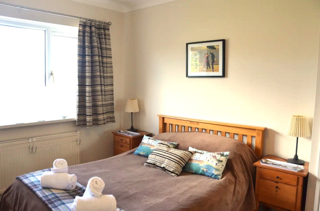 Double bed in bedroom 2 in The Little Red House Mumbles holiday cottage.